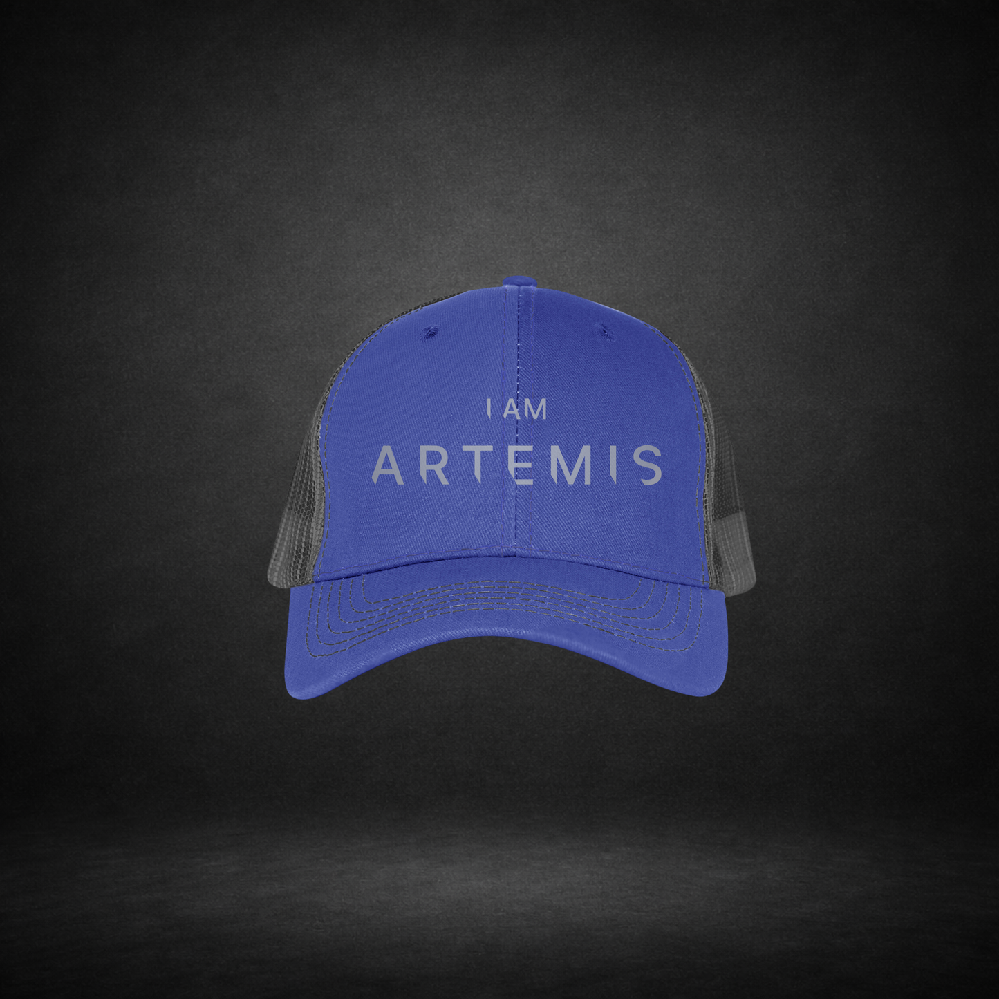 Blue cap with 'I AM ARTEMIS' text on a dark background