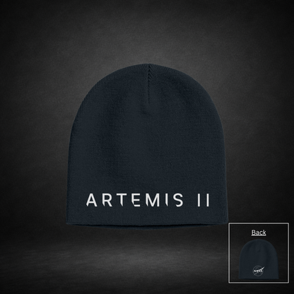 Black beanie with 'ARTEMIS II' text on one side and NASA Meatball Logo on the other side on a dark background
