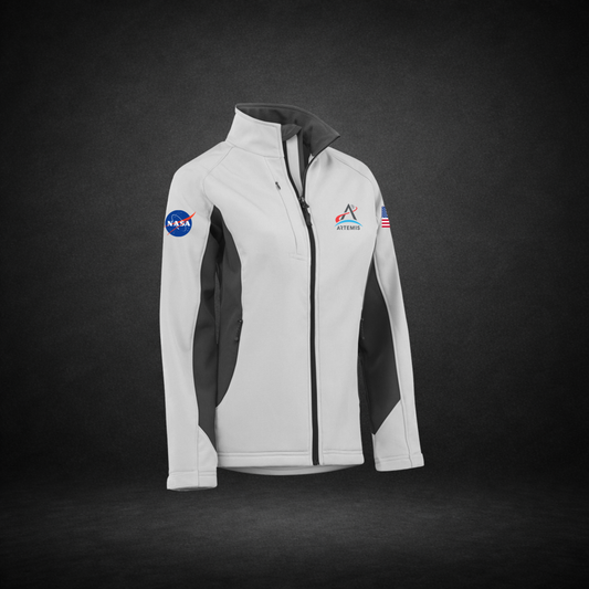 White and black jacket with NASA Meatball, Artemis Logo, and American Flag on a dark background