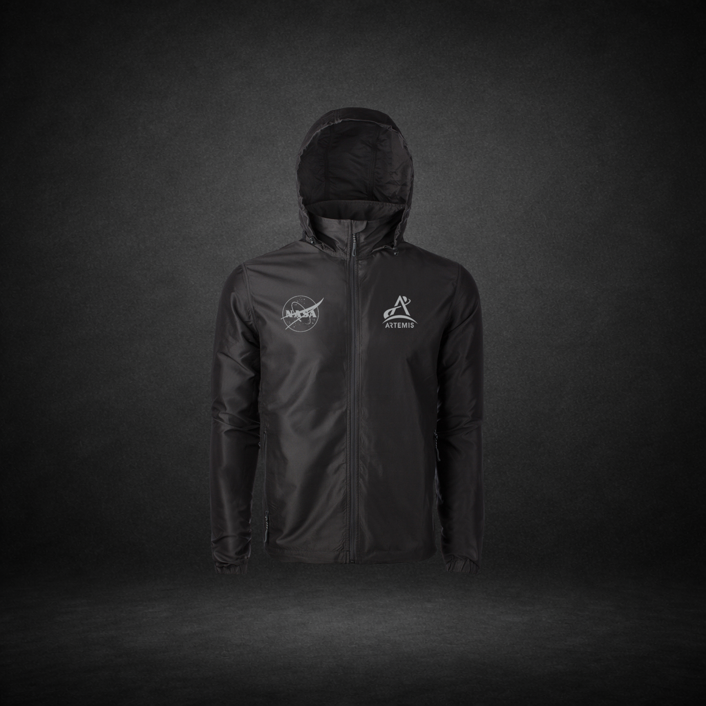 Black windbreaker with NASA Meatball and Artemis logos on a dark background