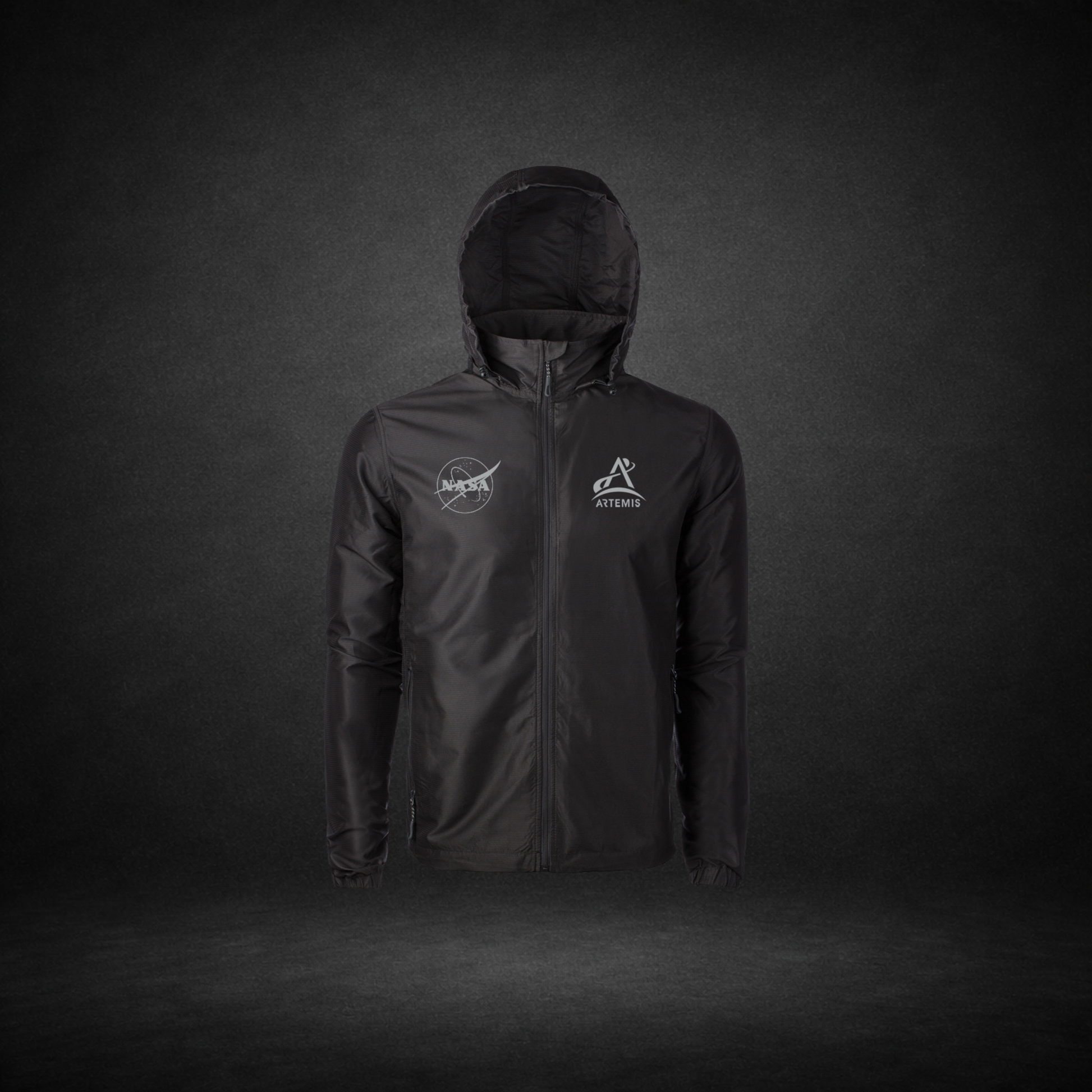 Black windbreaker with NASA Meatball and Artemis logos on a dark background