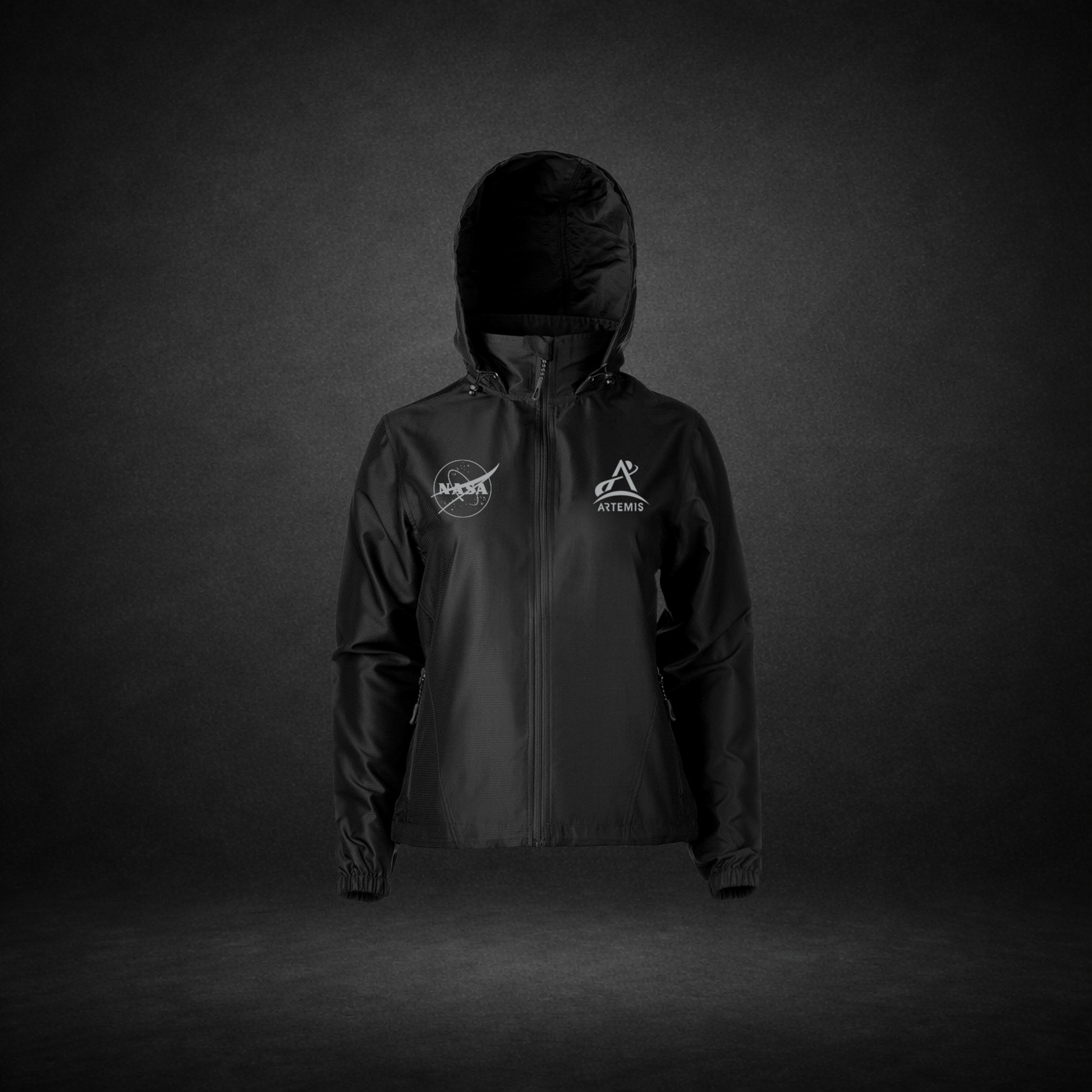 Black windbreaker with NASA Meatball and Artemis logos on a dark background