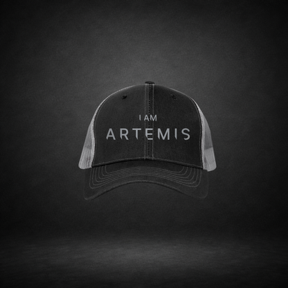 Black cap with 'I AM ARTEMIS' text on a dark background