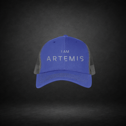 Blue cap with 'I AM ARTEMIS' text on a dark background
